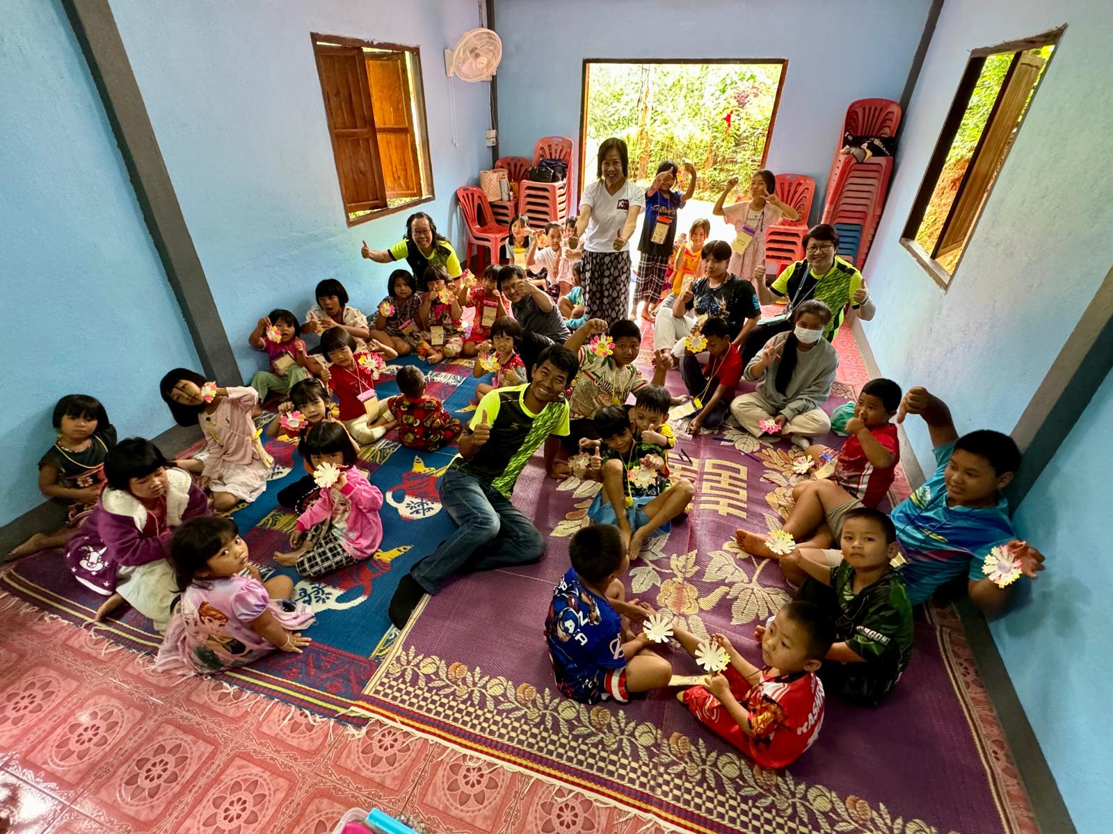 Volunteers distributing gear to children at a local martial arts school